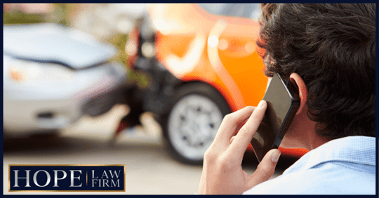 man on phone in front of car accident