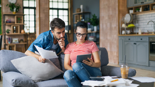couple reviewing documents on a tablet