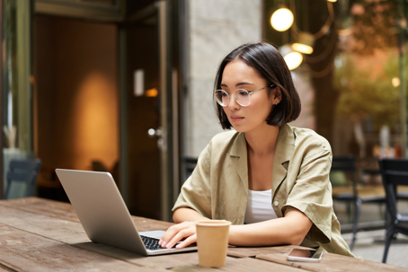 woman working on laptop at a cafe