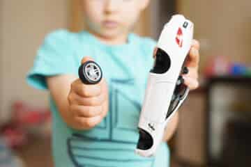 boy holding a broken toy car