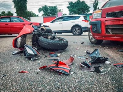 red motorcycle on pavement following a crash