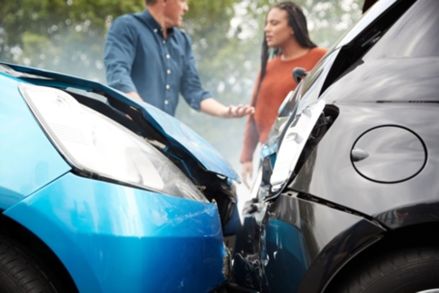 people arguing after a car accident