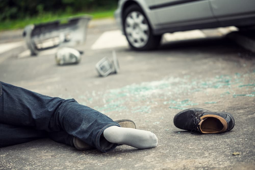 Close-up of a casualty at a traffic incident site after a car collision. Concept of hit and run accident.