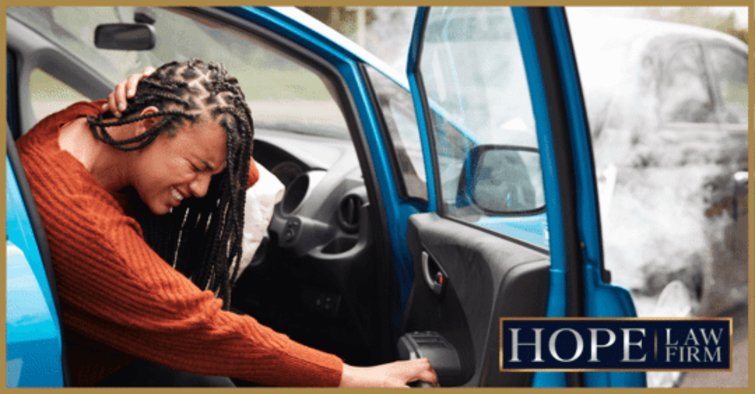 girl holding head after car accident