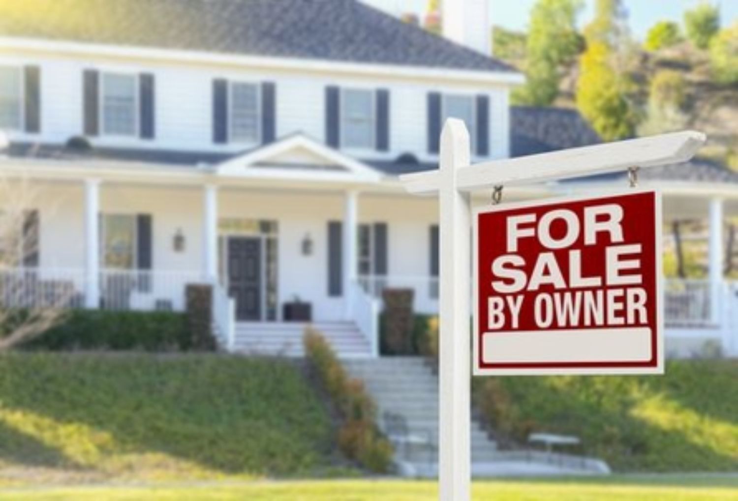 house with For sale by owner sign