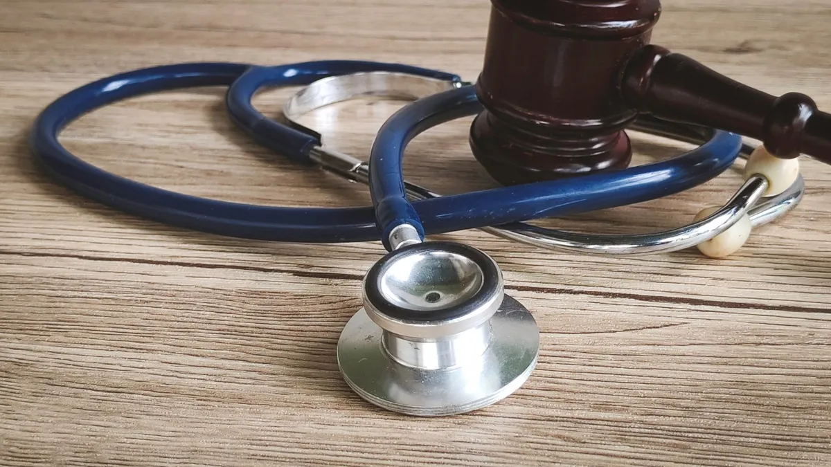 Judge's gavel resting on a stethoscope